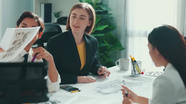 Business woman working and discussing about house model while businessman handed document about architectural model to investor sitting at meeting table with blueprint scattering around. Alimentation.