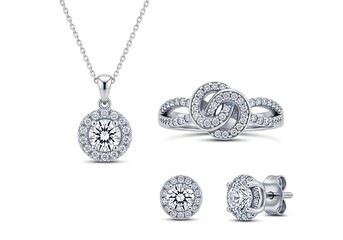 Elegant diamond jewelry set including necklace ring and earrings isolated on white background
