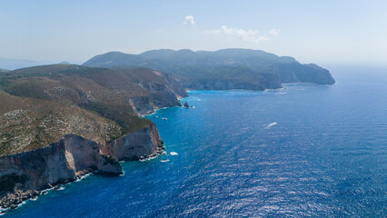 Stunning aerial coastline of Plakaki beach Zakynthos Greece with limestone walls turquoise water rugged shoreline and deep blue Ionian horizon