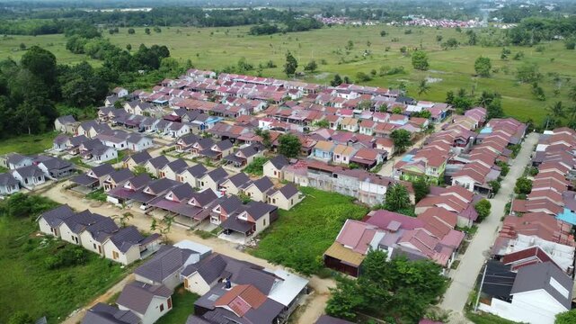 Aerial view of a residential area, some of which is still under construction, surrounded by agricultural areas
