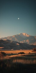 A serene nighttime desert scene with moonlit dunes, towering mountains, and clear starry sky, showcasing nature's tranquil beauty.