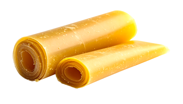 Two rolled sheets of translucent, amber-colored, slightly glossy, pliable material, possibly a food product or wax, rest on a plain background