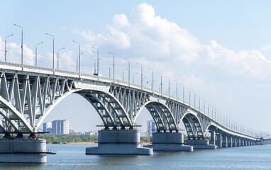 Naklejka premium The bridge through the river Volga. Saratov.The bridge over the Volga River between the cities of Saratov and Engels. Panorama of the city and the Saratov bridge across the Volga river. Russia. 