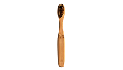 A light brown bamboo toothbrush with dark brown bristles, displayed against a black background.  The handle is subtly tapered