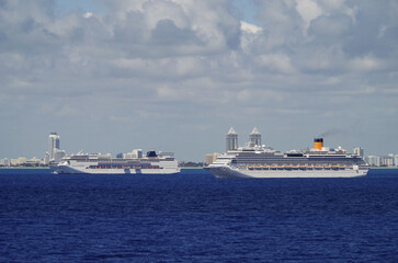 Italian family cruiseships cruise ship liners Armonia and Fortuna with Miami Beach, Florida skyline ready for Caribbean summer cruising