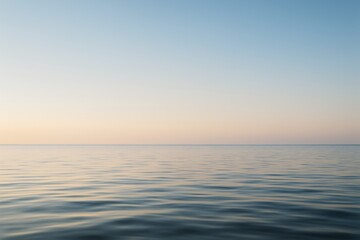Obraz premium Calm ocean surface with soft ripples under a pastel sky, perfect natural background for banner, poster, or design mockup concept template. Ai generative