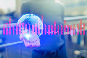 Businesswoman using international connections and economic graphs on world map backdrop.