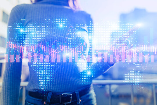 Businesswoman using abstract line charts and international world map.