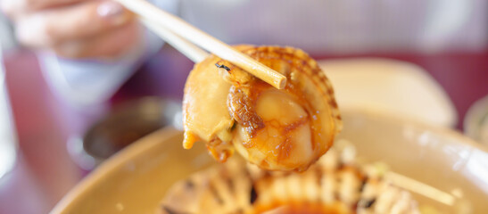 grilled Scallop in Matsushima fish market, seafood famous and popular of Matsushima bay in Miyagi Prefecture, Tohoku, Japan