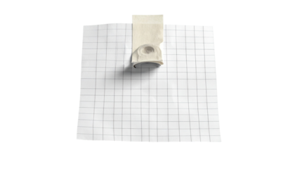 Rectangular white gridded paper with small, light-gray object affixed