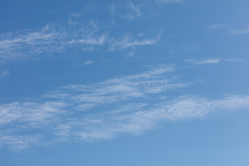 A clear blue sky with a few clouds