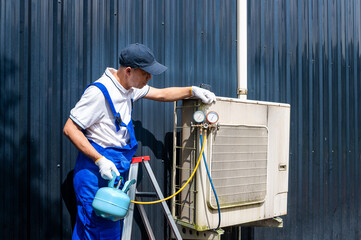 HVAC Technician Inspecting AC Unit: A skilled technician meticulously examines an air conditioning unit, highlighting the importance of climate control in a professional environment.