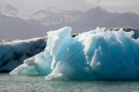 Jokulsarlon Iceland, blue ice of iceberg in afternoon sunshine - Powered by Adobe