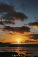 Obraz premium Golden Hour Splendor. Breathtaking Ocean Sunset with Waves Gently Caressing the Shoreline