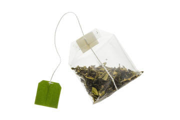 A single tea bag filled with loose green tea leaves, isolated on a transparent background. background removed