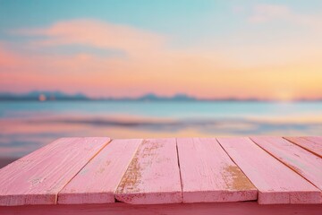 Pink wooden planks in focus over a blurred sunset seascape