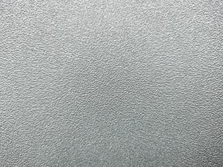 Close-up of textured metallic surface with fine, pebble-like pattern. Ideal for texture, industrial, neutral background, or subtle-themed visual content