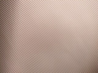 Fototapeta premium Close-up of textured surface with raised diamond pattern in matte finish. Ideal for industrial, grip, background, or design-themed visual content