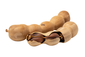 Close-up of two ripe tamarinds, one opened to reveal its dark brown seeds. background removed