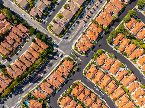 Top-down aerial view of symmetrical suburban neighborhood with red tile rooftops and intersecting streets in Long Beach, California