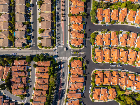 Top-down aerial view of symmetrical suburban neighborhood with red tile rooftops and intersecting streets in Long Beach, California