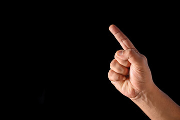 Male Hand Pointing Forward Gesture Isolated Against a Dark Background