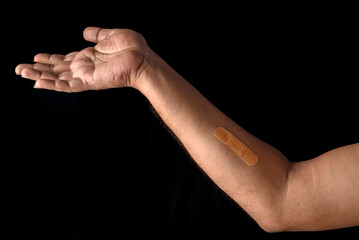 Close-Up of Bandage on an Arm with Dark Background