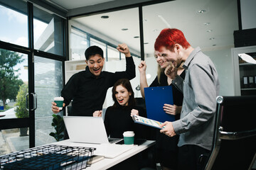 Four colleagues engage in a collaborative office meeting, using laptops, tablets, and documents to brainstorm ideas, discuss strategies,share insights, fostering teamwork, productivity, professional