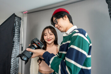 Obraz premium Asian beautiful woman model and cameraman working in photography studio.