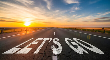 Lets go text on cracked asphalt road at sunset, motivational concept of overcoming challenges and obstacles, new beginning on difficult journey to success.