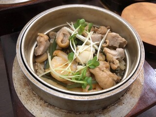 Japanese kamameshi rice with clams and chicken in iron pot