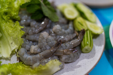 Fresh raw peeled shrimp placed on dish