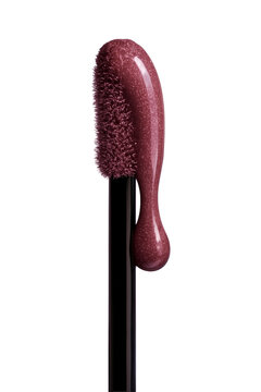 Glittering berry lip gloss dripping from applicator, beauty product close up.