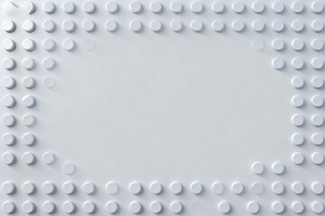White textured surface with raised circular dots arranged in a rectangular border pattern