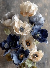 A bouquet of handcrafted paper poppies in muted blues and creams against a textured gray backdrop.  The flowers exhibit delicate, ruffled petals and subtle shading