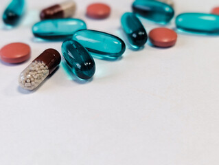 Assorted pills and capsules on white background, healthcare and medicine concept
