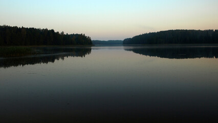 sunrise landscape by the lake, calm and quiet morning, morning dew on the meadow, autumn vegetation