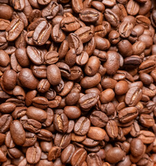 Close up of roasted brown coffee beans background for cafe or food industry concept