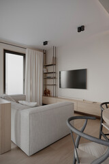 Modern minimalist living room with neutral colors, sleek furniture, and soft lighting, featuring a cozy sofa, wooden shelf, and a wall-mounted TV.