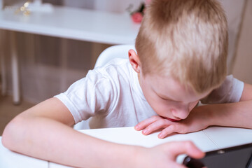 A boy with hearing aids engages with a smartphone, playing mobile games with focused enjoyment....