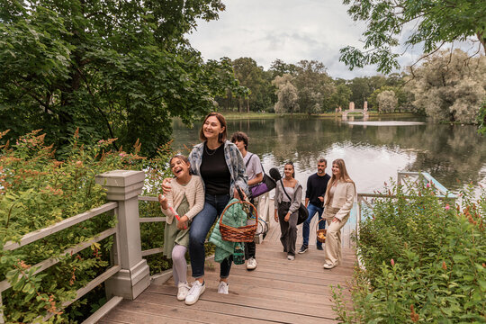 family walks up a wooden staircase after a picnic by the lake.