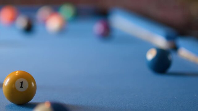 Yellow Billiard Ball Rolling on Blue Pool Table Surface - Powered by Adobe