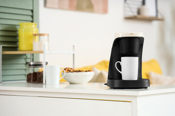Coffee machine with cup on shelf in office, closeup