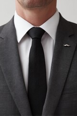 Sharp dressed man showcasing stylish tie and subtle mustache pin