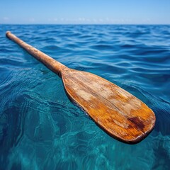 Wooden paddle floats on turquoise water
