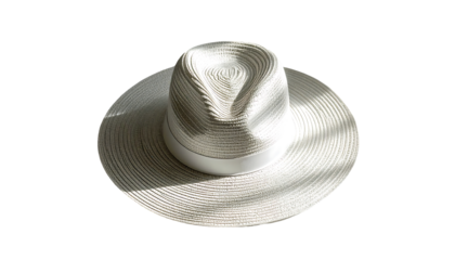 A cream-colored fedora with a wide brim, a subtle woven texture, and a crisp white band sits on a black background, illuminated by sunlight