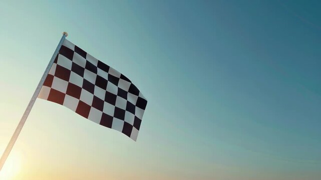 Checkered flag waving against clear sunrise sky, symbolizing start or finish of race