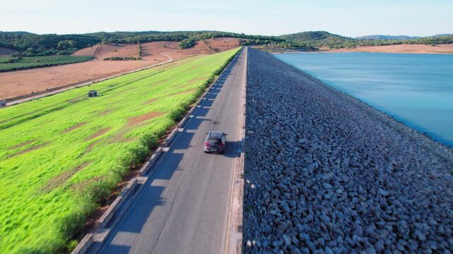 Car driving on a road along the Embalse de Barbate in C&aacute;diz, Spain