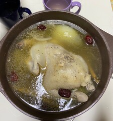 Samgyetang, a hearty Korean ginseng chicken soup, featuring a whole young chicken stuffed with rice, garlic, jujube, and herbs. A nourishing dish perfect for health and comfort.