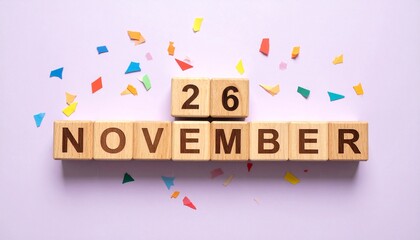 Wooden Blocks with Date 26 November. Calendar for birthday or anniversary on solid colored background with confetti